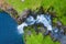 Aerial view of Mulafossur waterfall in Gasadalur village in Faroe Islands, North Atlantic Ocean. Photo made by drone from above.