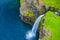 Aerial view of Mulafossur waterfall in Gasadalur village in Faroe Islands, North Atlantic Ocean. Photo made by drone from above.