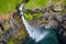 Aerial view of Mulafossur waterfall in Gasadalur village in Faroe Islands, North Atlantic Ocean. Photo made by drone from above.