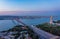 Aerial view of multilane road leading on suspension bridge over Tagus river in twilight time, Lisbon, Portugal.