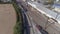 Aerial view of multiple antique restored steam engines in a train yard steaming up blowing smoke