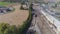 Aerial view of multiple antique restored steam engines in a train yard steaming up blowing smoke