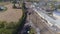 Aerial view of multiple antique restored steam engines in a train yard steaming up blowing smoke