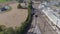 Aerial view of multiple antique restored steam engines in a train yard steaming up blowing smoke