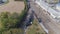 Aerial view of multiple antique restored steam engines in a train yard steaming up blowing smoke