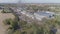 Aerial view of multiple antique restored steam engines in a train yard steaming up blowing smoke