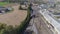 Aerial view of multiple antique restored steam engines in a train yard steaming up blowing smoke