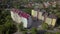 Aerial view of multistory apartment building in green residential area.