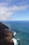 An aerial view of the Napali Coastline and the Pacific Ocean with boats sailing in the water in Kauai, Hawaii