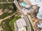 Aerial view of a narrow road with vehicles driving along the wild south coastline facing the Atlantic Ocean wit crispy waves