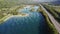 Aerial view of natural landscapes and highway asphalt road along lakes and mountains