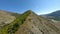 Aerial view natural mountain ridge forest trees and grass cliff peak texture at sunny natural valley