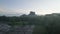 Aerial view of nature in tropical forest in morning. Silhouette of Sigiriya Rock against sunrise sky. Backwards reveal