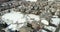 Aerial view of a neighborhood with a nearby playground in winter