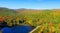 Aerial view of New England foliage and lake on a sunny day