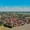 Aerial view of a new housing estate with detached houses at the edge of a village