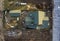 Aerial view of new residential house cottage and garage or barn with shingle roof on fenced yard on sunny day