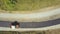 Aerial view of new road construction with steam roller machine at work.