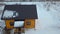 Aerial view of new wooden house cottage in winter field.