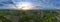 Aerial view of a nice windmill with sunset, Agriculture fields and different variety of harvest, Panorama view of forest Aerial