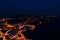 Aerial view of the night city of Porec in lights on the Adriatic Sea. Night photography from a drone.