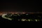 Aerial view of night town from Hill after sunset - modern city with spectacular nightscape panorama. aerial view, night