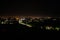 Aerial view of night town from Hill after sunset - modern city with spectacular nightscape panorama. aerial view, night city with