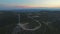 Aerial view of nine windmills for the production of electric energy, at sunset