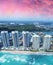 Aerial view of North Miami Beach skyscrapers with sun and clouds