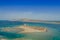 Aerial view of nuraghe in a island in Mediterranean sea next to Sardinia coast