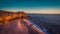 Aerial view of ocean, north Beach and Nazare lighthouse at sunset, Portugal