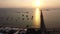 Aerial View of the Ocean at Sunset with a Pier and Boats near the Shore, A Long Pier Near the city