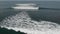 Aerial view of ocean surface with waves rolling to beach. Drone shot towards waves splashing with white foam. Nature