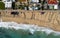 Aerial view of ocean waves breaking on a sandy beach. Beach erosion after coastal flooding.