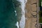 Aerial view of ocean waves breaking on a sandy beach. Beach erosion after coastal flooding.