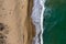 Aerial view of ocean waves washing a sandy shoreline