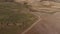 Aerial view off road 4x4 car driving along gravel trail path. Drone view on offroad vehicle on desert road travelling in