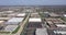 Aerial view of an office park with low-rise buildings near a highway in a suburban setting