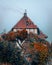 Aerial view of old building surrounded by autumn dense trees