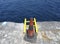 Aerial view of old cone on shipping dock along with yellow life ladder. Port safety background. Stair hang on the pier