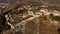 Aerial view of the old fortress in mountains. Panorama from height to the ruins of the fort.