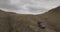 Aerial view of an old jeep rides on high hills around the city of Ulan-Ude, Siberia, Russia. 4K