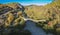 Aerial view of old Kalogeriko triple arched stone bridge on Vikos canyon, Zagorohoria, Greece, Europe