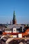 aerial view of old tower with tall spire and cityscape