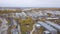 Aerial view of one Russian city`s industrial zone, hangars, plants and industrial equipment. Clip. Construction and