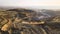 Aerial view of open pit mine of sandstone materials for construction industry with excavators and dump trucks. Heavy