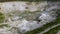 Aerial view of opencast mining quarry with lots of machinery at work - view from above.