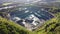 Aerial view of opencast mining quarry in the middle of the forest