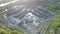 Aerial view of opencast mining quarry in the middle of the forest