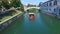 Aerial view of orange boat on green river Ljubljana, Slovenia.